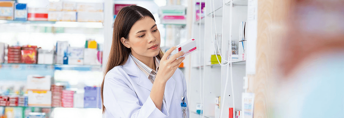 A woman looking at a prescription box