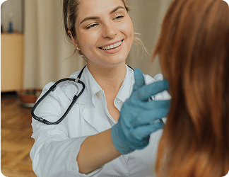 A woman in a labcoat inspecting a patient's face